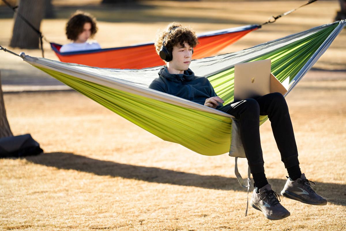 Foreground, Ian Hauver-Radloff '26 and Theo Ollier '26 relax in hammocks during a relatively warm winter afternoon in Tava Quad on 2/21/23. Photo by Lonnie Timmons III / Colorado College.
